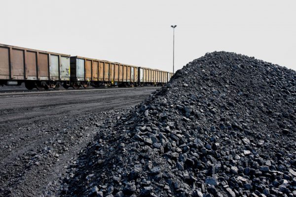 Piles of processed coal next to a rail siding waiting to be put on a train for transporting to a coastal port